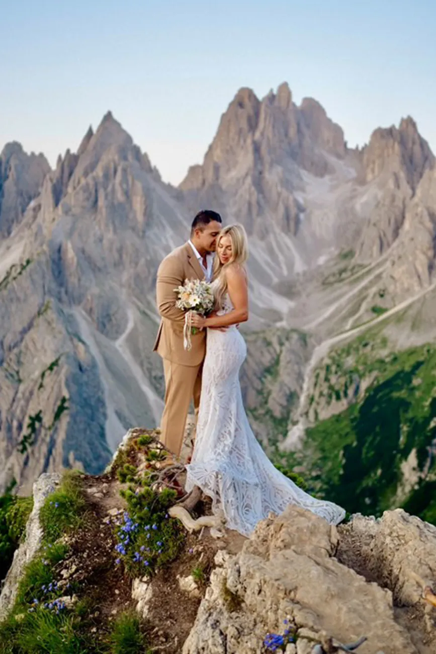 Couple embracing in front of Dolomites peaks