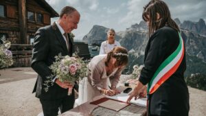Couple signing the register at a civil ceremony in Cortina d'Ampezzo