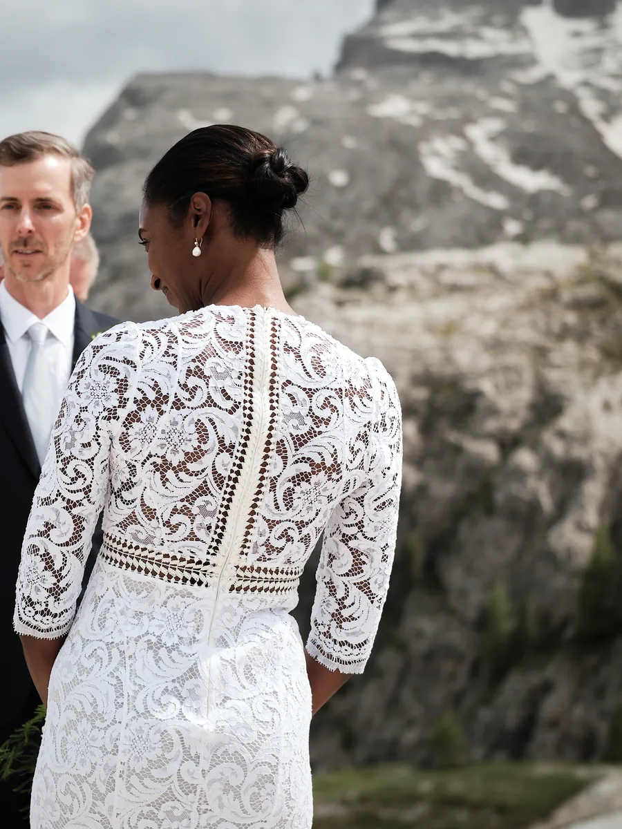 Bride and groom facing the Dolomites