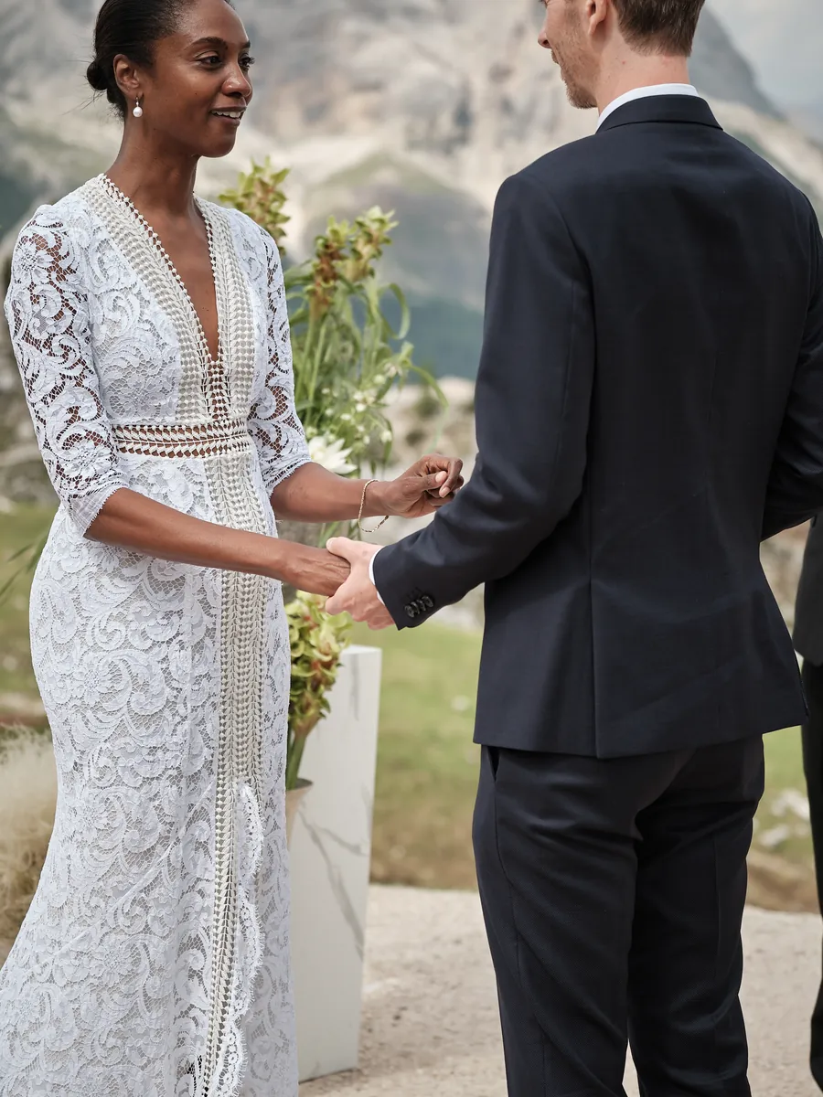 Bride and groom holding hands during their vows at the Cinque Torri