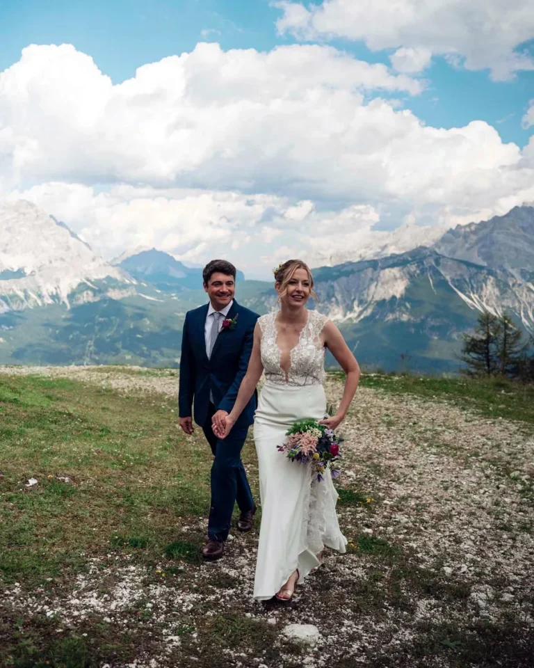 Bride and groom in a Dolomites meadow