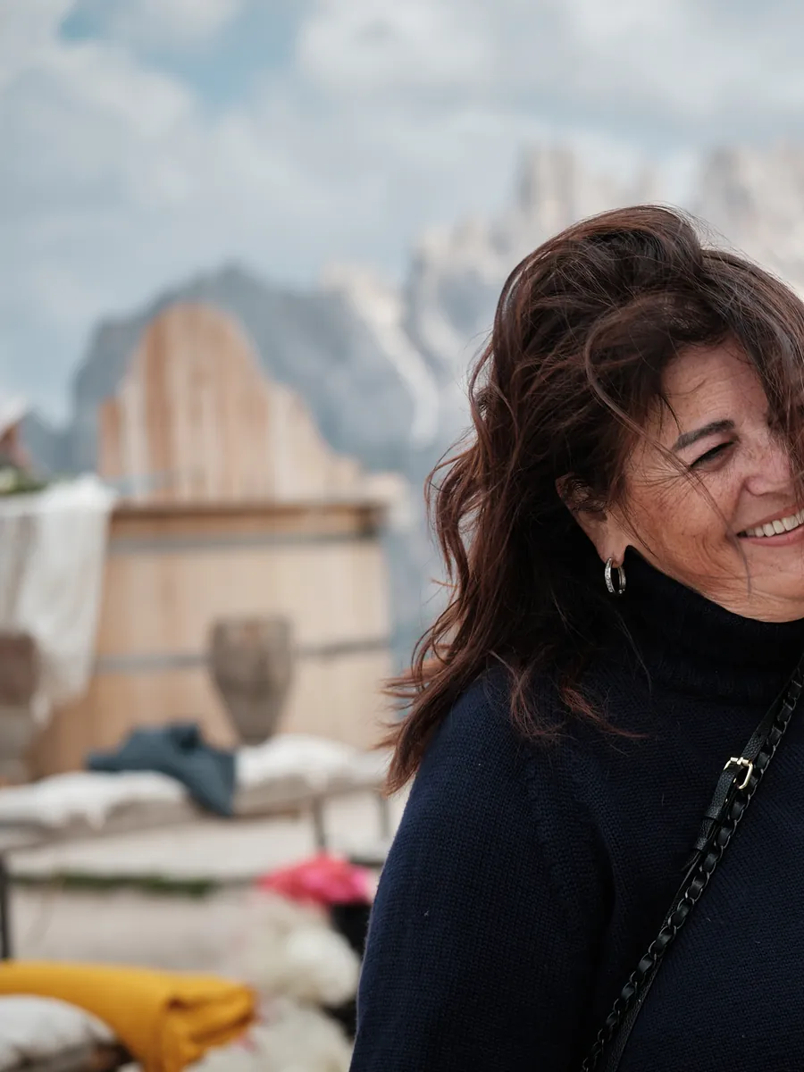 Viviana Reatti laughing with guests at a wedding in the Dolomites