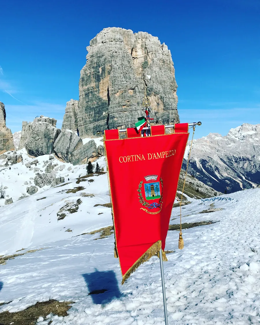 The banner of Cortina d'Ampezzo at the Cinque Torri in winter