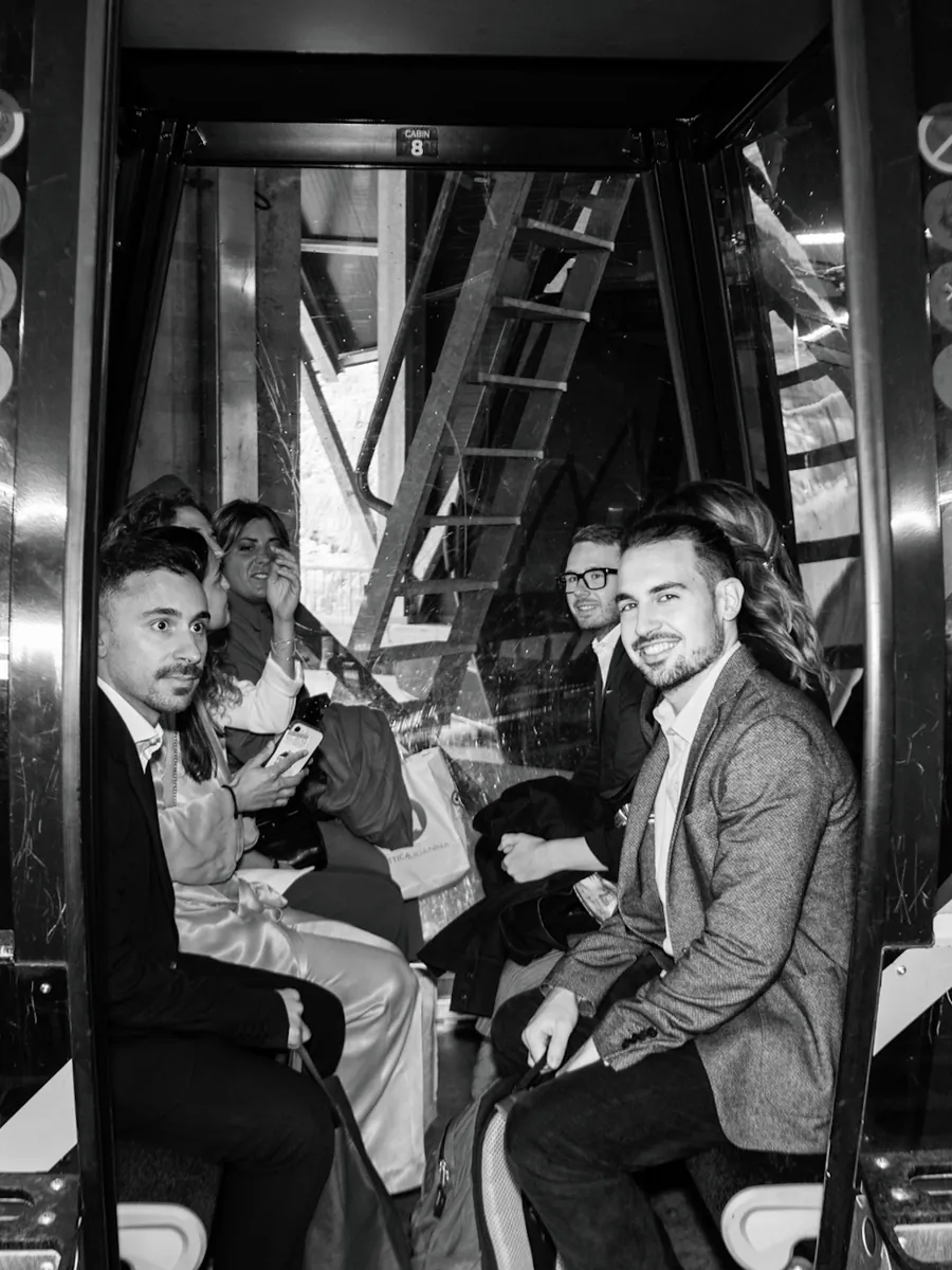 Wedding guests riding a cable car in the Dolomites