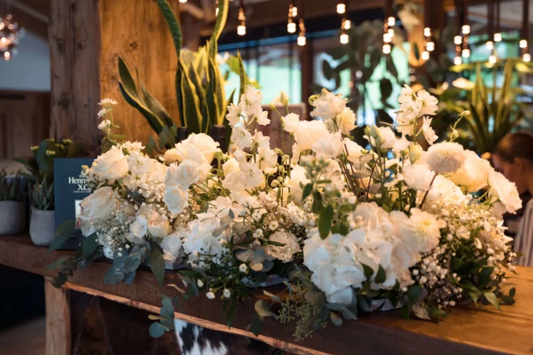Detail of a white floral wedding set-up in a mountain lodge in Cortina