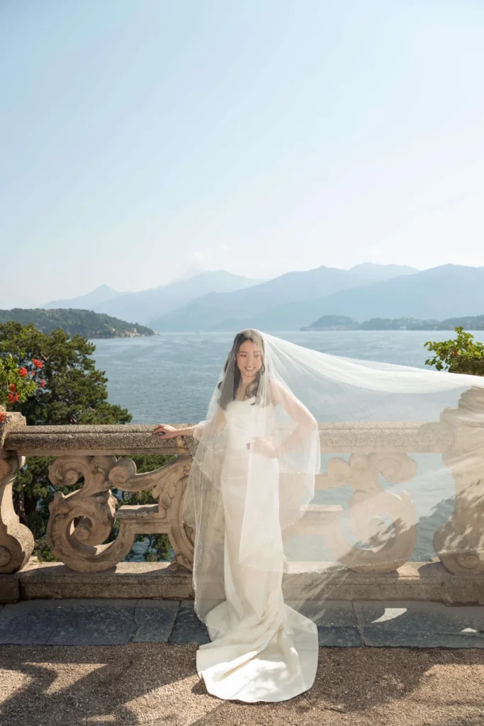Bride with her veil in the wind on a Lake Como terrace