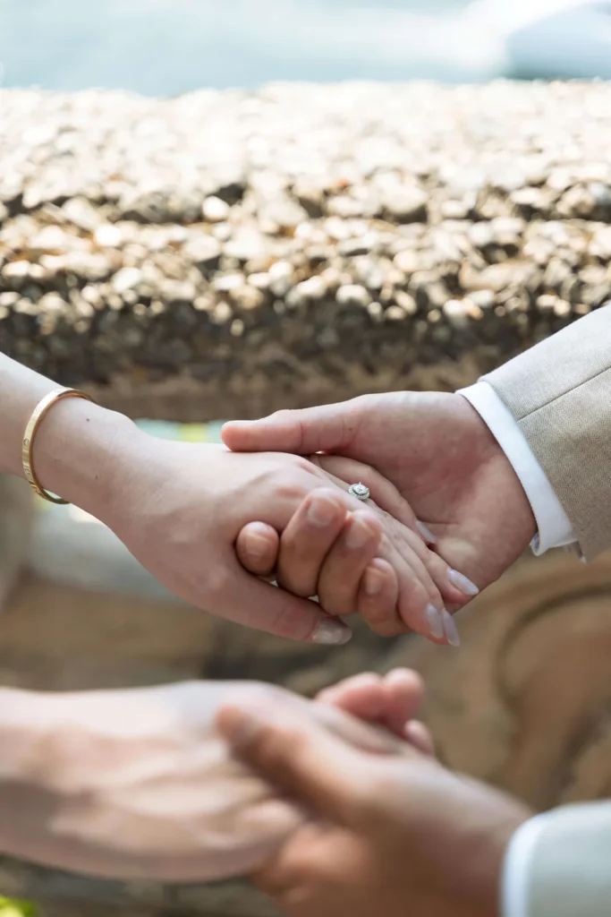 Bride and groom holding hands, detail