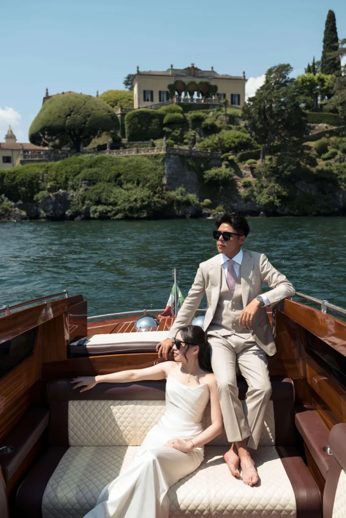 Couple on a classic wooden motorboat on Lake Como