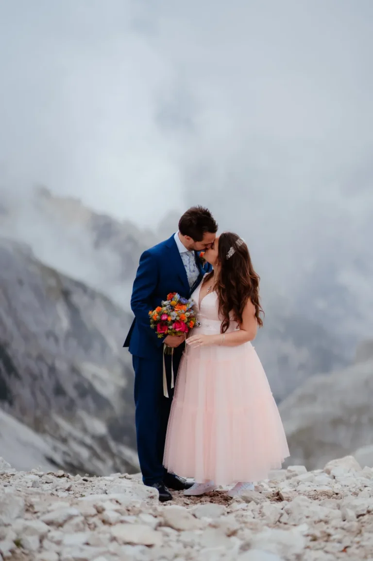 Maria and Enrico kissing among the clouds in the Dolomites