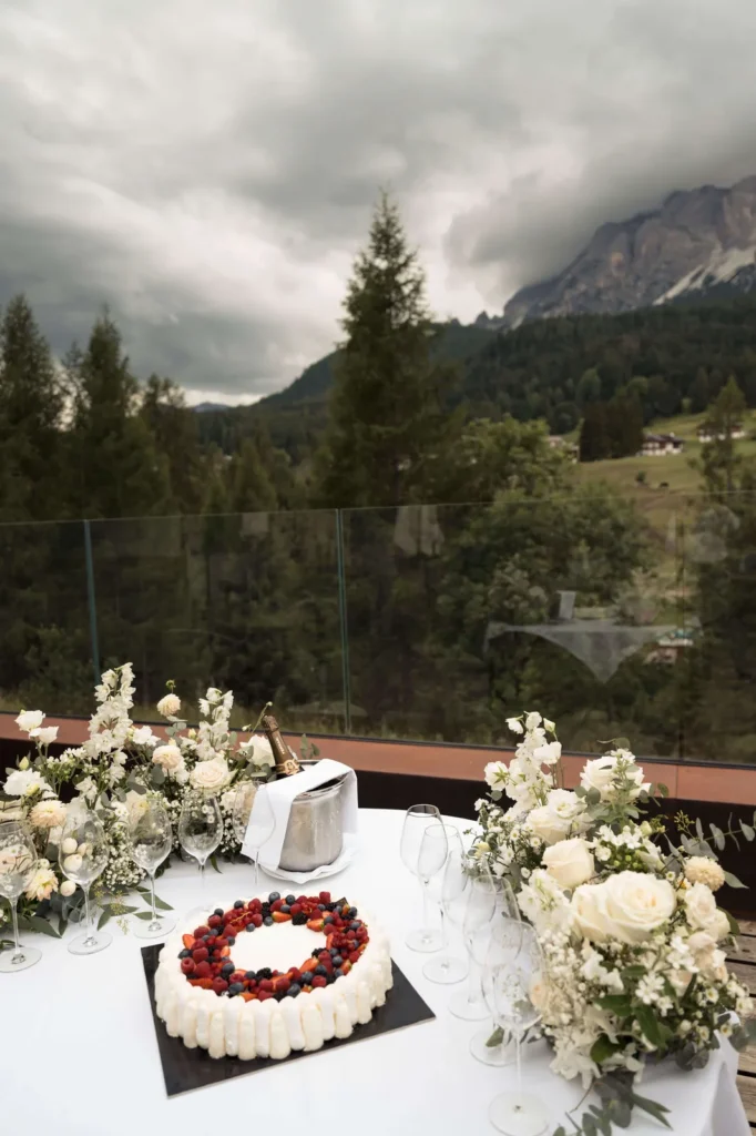 Wedding cake with berries on a terrace facing the Dolomites