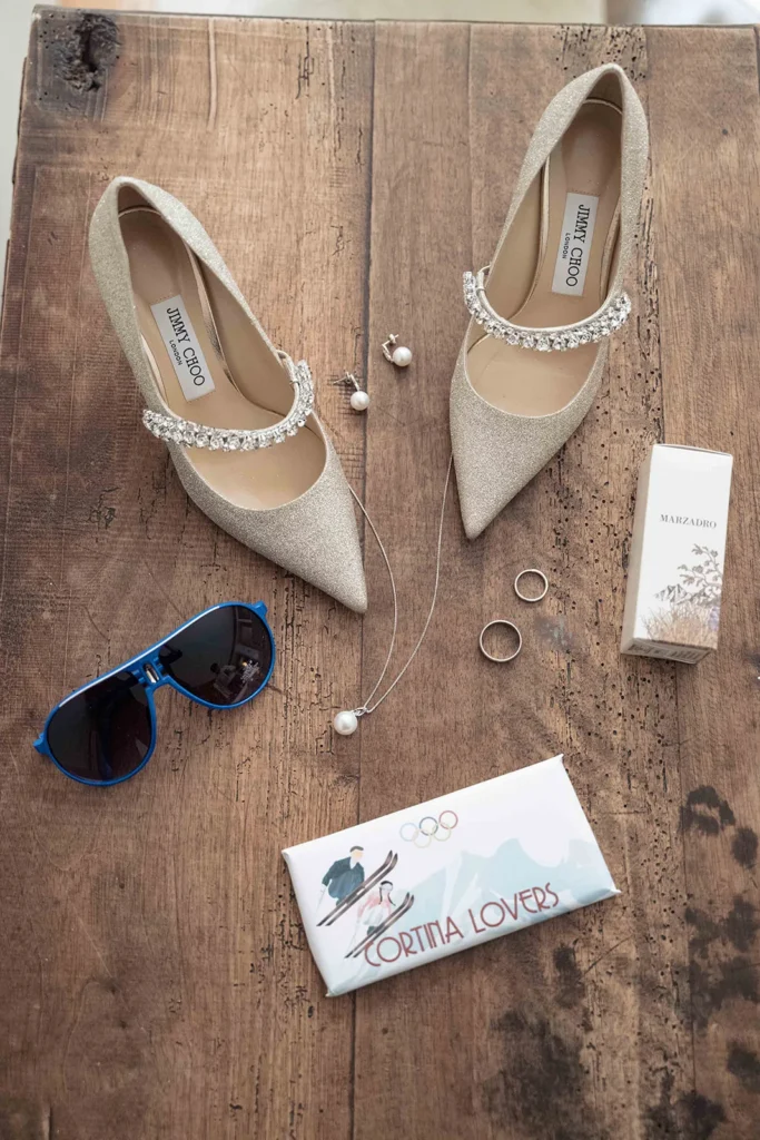Bridal shoes, sunglasses and Cortina Lovers wedding favours