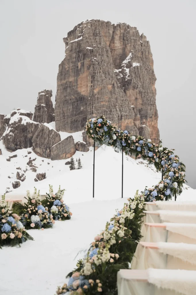 Floral arch in the snow with the Cinque Torri behind