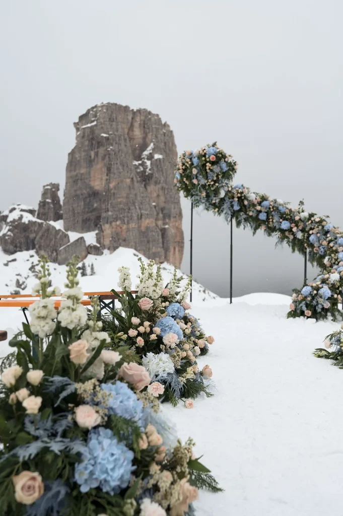 Blue and white wedding flowers in the snow at the Cinque Torri