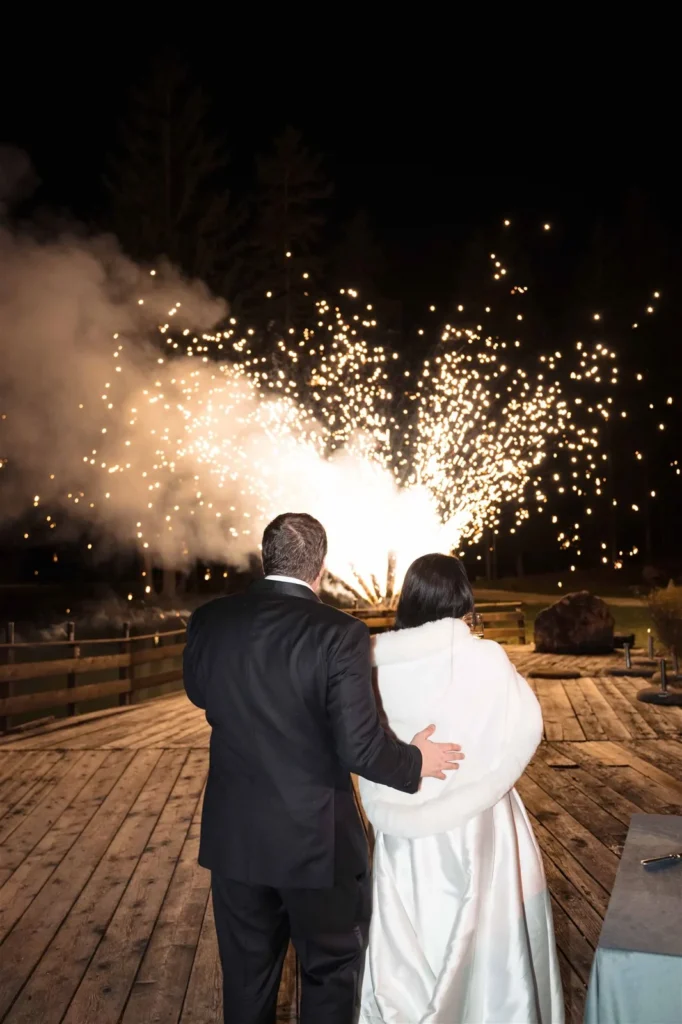 Bride and groom watching fireworks on the terrace